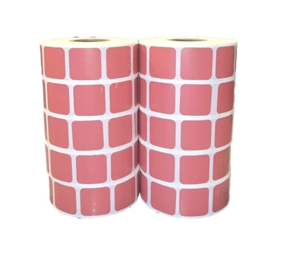 Two rolls of red waterproof target pasters standing upright side by side, each roll three pasters wide on white backing paper.