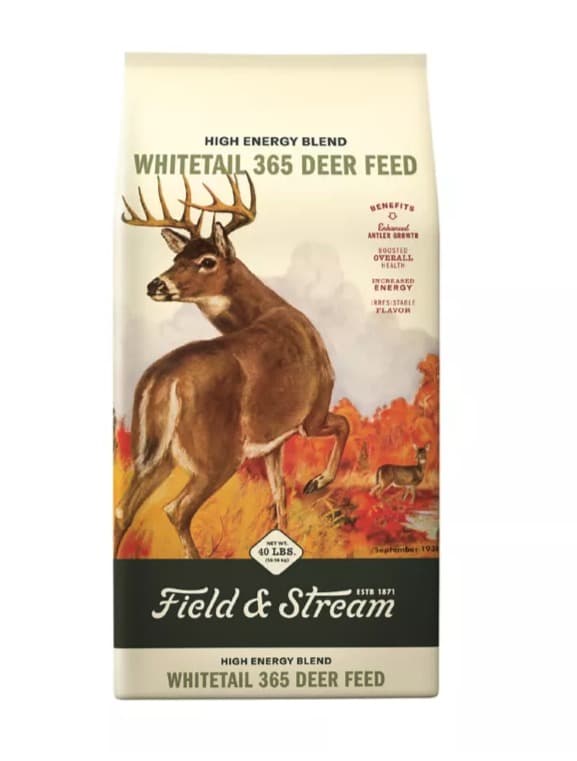 A 40 lb bag of Field & Stream Whitetail 365 High Energy Blend deer feed, a painted whitetail buck looking back over its shoulder in an autumn field, the Field & Stream script on a green band at the bottom.