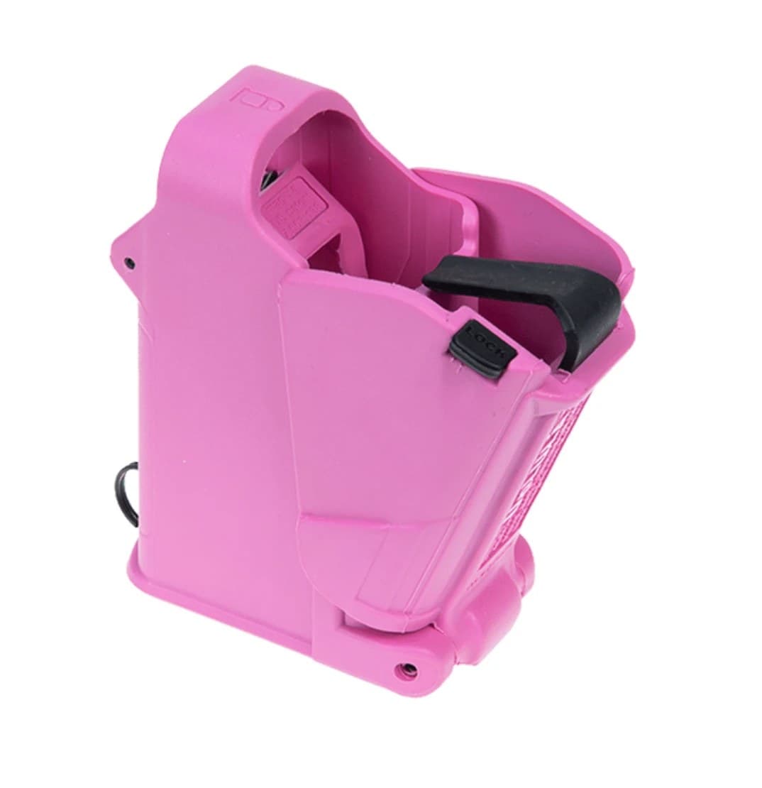 A pink Maglula UpLULA pistol magazine loader seen from the front three-quarters, the black lock lever and pull tab on its right side, jaws open at the top.