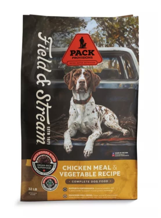 A 32 lb bag of Field & Stream Pack Provisions Chicken Meal & Vegetable Recipe dog food, a German shorthaired pointer lying in the bed of a pickup on the front, the Field & Stream script down the left edge and a gold band along the bottom.