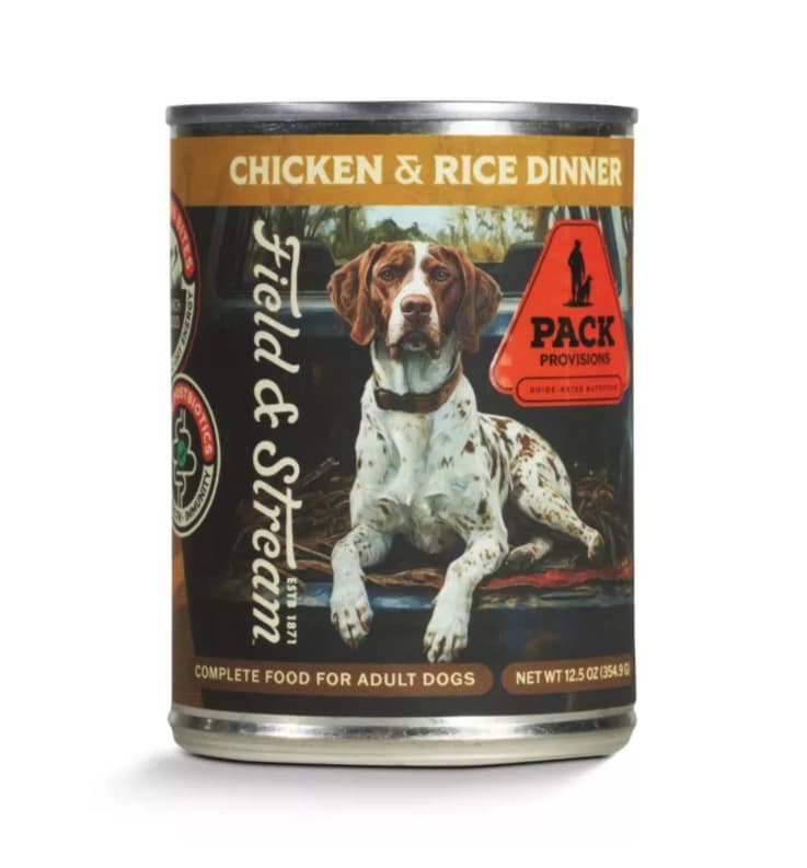 A 12.5 oz can of Field & Stream Pack Provisions Chicken & Rice Dinner wet dog food, a German shorthaired pointer in a pickup bed on the label under a gold band.