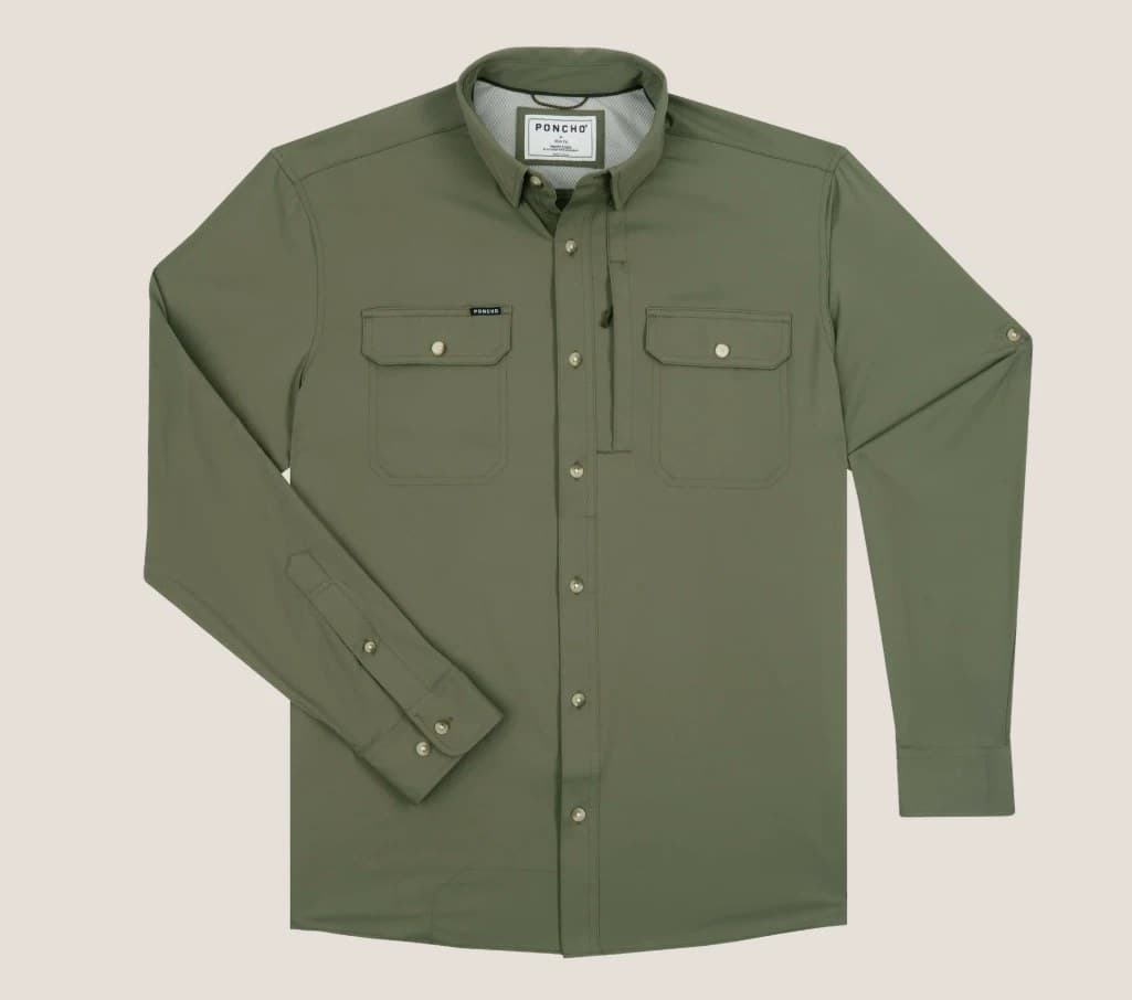 Poncho's The Gunnison long-sleeve shirt in Moss Green laid flat on a warm grey backdrop, two flap chest pockets, the left sleeve folded across the body, a small Poncho label on the pocket.